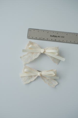 A pair of white hair clip