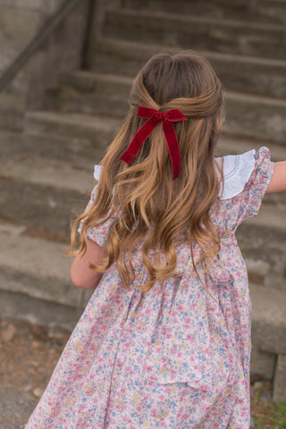 A pair of burgundy hair clip/ties