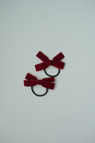 A pair of burgundy hair clip/ties